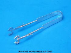 A pair of white metal seafood tongs,
