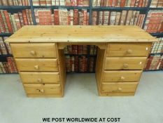 Pine twin pedestal desk with four drawers to each side (height 78cm width 144cm)