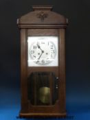 An oak cased two train wall clock