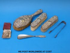 A set of Georgian hallmark silver sugar tongs, (44g) three hallmarked silver-mounted brushes,