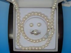 A cased suite of pearl jewellery comprising necklace, bracelet,