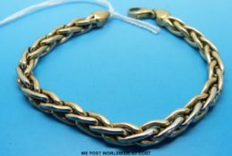 A 9ct gold bi coloured bracelet of plaited design (14.