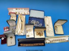 A large collection of costume jewellery to include a filigree brooch, paste brooches,