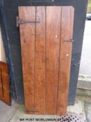 An 18th/19th century elm country style planked door (176 x 74cm)