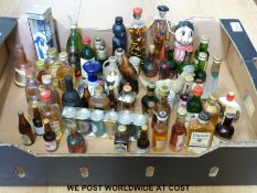 A collection of alcohol miniatures to include novelty china and glass bottles in the form of light