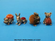 Four miniature novelty pin cushions in the form of a pig, a hare, a bear,