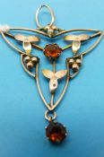 An Edwardian pendant set with citrine in a flower design