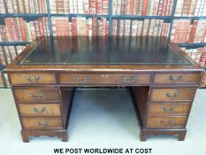 A mahogany twin pedestal desk with gilt tooled leather inset top (H75, W151,