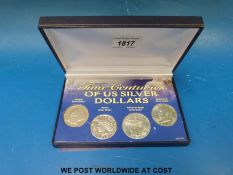 A boxed set of four silver coins 