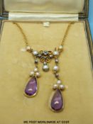 A gold necklace set with pearls,