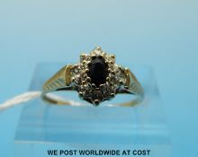 A 9ct gold ring set with a sapphire surrounded by cubic zirconia (size N)