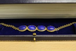 An 18ct gold three stone lapis-lazuli fancy link bracelet.