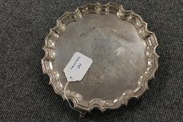 A silver card tray with scalloped edge,