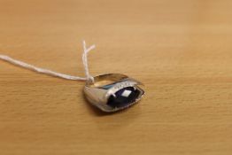 An 18ct white gold diamond and blue stone ring.