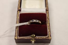 An 18ct gold diamond and sapphire half eternity ring. CONDITION REPORT: Good condition.