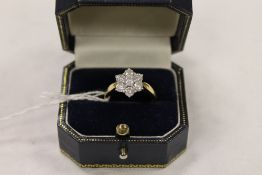 An 18ct gold diamond cluster ring. CONDITION REPORT: Good condition.