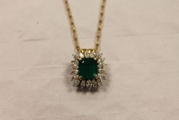 An 18ct white and yellow gold Columbian emerald and diamond pendant, suspended upon a 9ct gold