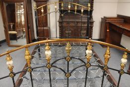 A late Victorian 4'6 cast iron, lacquered brass and ceramic bed stead.