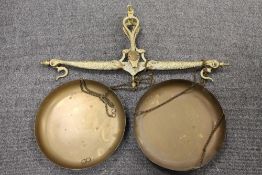 An early twentieth century brass balance, with fish decoration and fitted weights, height 86.5 cm.