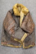 An early twentieth century military issue brown leather and sheep skin bomber jacket. CONDITION