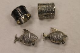 A pair of continental white metal salts modelled as fish, together with a niello napkin ring and