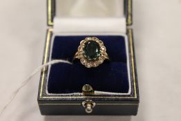A diamond and tourmaline cluster ring mounted in yellow metal. CONDITION REPORT: Good condition, the