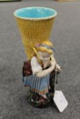 A Minton figure of a lady holding a basket, height 23 cm. CONDITION REPORT: Fair condition, the