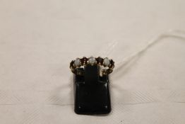 A 9ct gold opal and garnet ring CONDITION REPORT: Good condition.