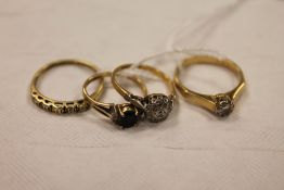 An 18ct gold ring set with diamonds together with a 9ct gold solitaire ring and two other 9ct gold