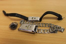 Two vintage analogue wrist watches together with a ring watch.