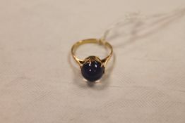 A 14ct gold cabochon ring. CONDITION REPORT: The blue stone unknown, thought to be a sapphire.