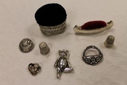 A silver teddy bear pendant, together with three silver brooches, two silver thimbles and two silver