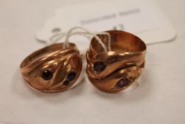A 9ct gold 'snake' ring set with amethysts, together with another ring similar. (2) CONDITION