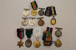 A silver volunteer officer's decoration on green suspension ribbon, together with eleven other WW