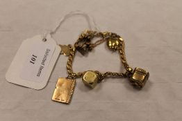 A yellow metal charm bracelet, 27g. CONDITION REPORT: Metal fineness of 9ct, 14ct and 18ct, the