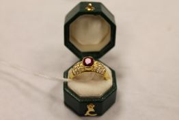 An 18ct gold ruby ring, approximately 1.08ct, with diamond encrusted shoulders. CONDITION REPORT: