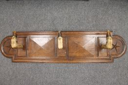 An early twentieth century oak deer hoof coat/gun rack, width 139 cm. CONDITION REPORT: Good