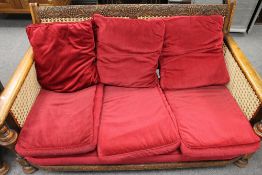 An early twentieth century carved oak bergere three piece lounge suite. (3) CONDITION REPORT: Good