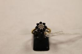 An 18ct gold diamond and sapphire cluster ring. CONDITION REPORT: Good condition.