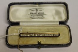 An 18ct gold enamel and diamond bar broo