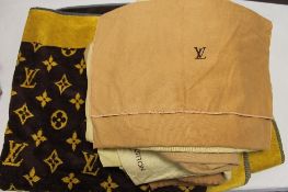 A Louis Vuitton bath towel, together with twelve dust bag and cloths.  CONDITION REPORT: Used but