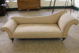 A Victorian chaise longue in pink upholstery.