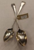 Two silver basting spoons. (2) CONDITION REPORT: Good condition, nineteenth century and early