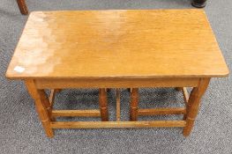 A nest of carved oak tables by 