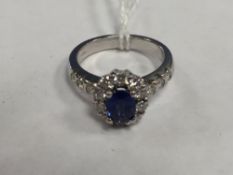 An 18ct white gold diamond and sapphire cluster ring set in platinum.