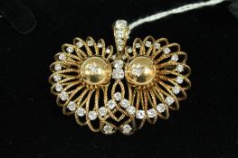 An 18ct gold pendant, set with forty-three diamonds, approximately 3.6ct, 32.9g, width 5.3cm.
