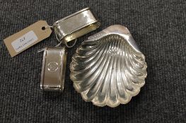 A pair of silver napkin rings, together with a butter shell. (3)   CONDITION REPORT: Good Time