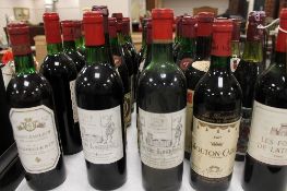 A collection of thirty bottles of wine - Chateau Lagrange 1972, Mouton Cadet 1967 and others. (30)