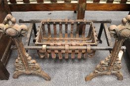 A nineteenth century cast iron fire grate with dogs.