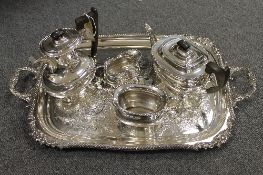 A four piece Sheffield plate tea service on tray with scalloped edge design. (5) CONDITION REPORT: